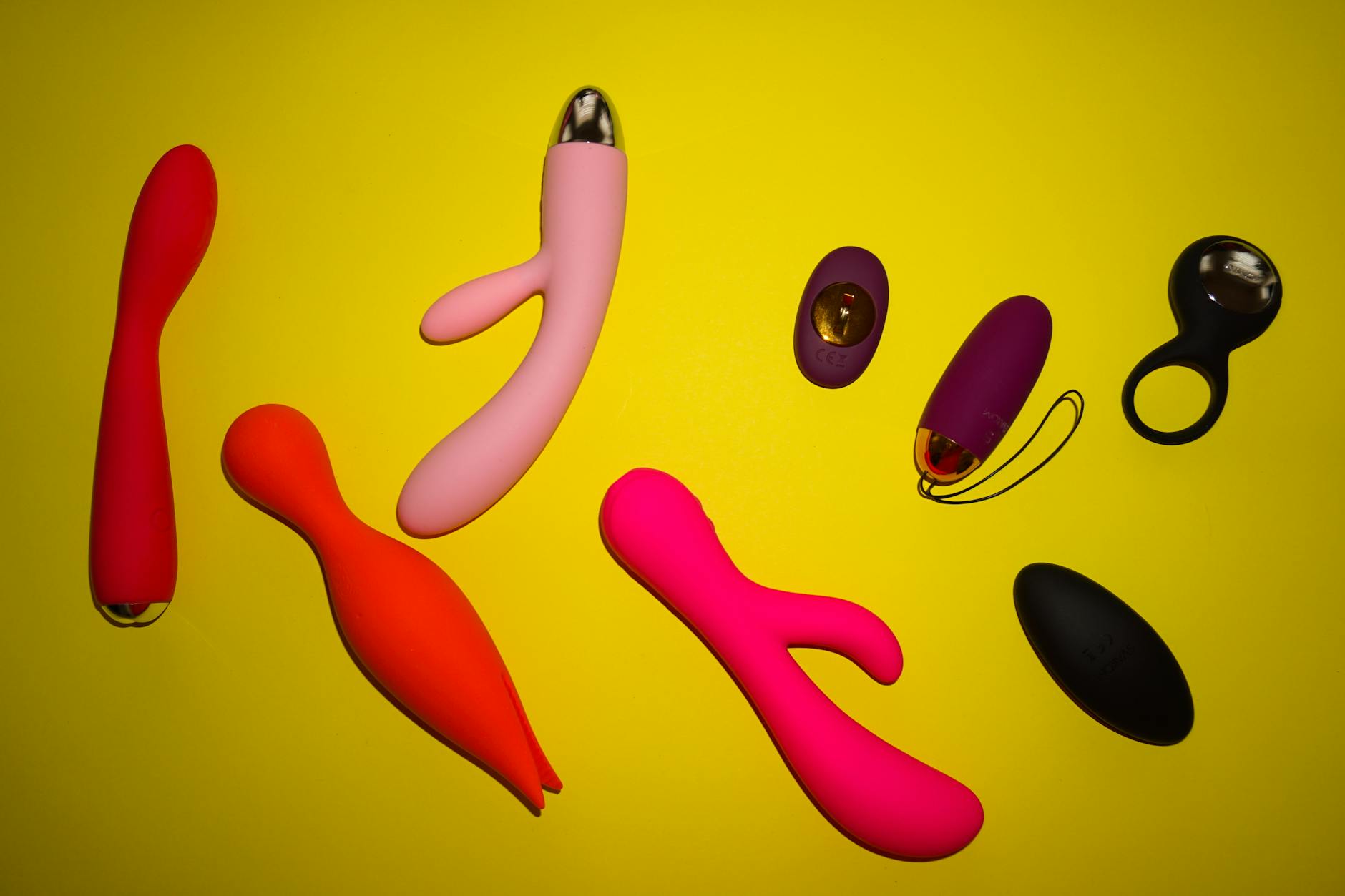 Woman holding colorful vibrators with confidence