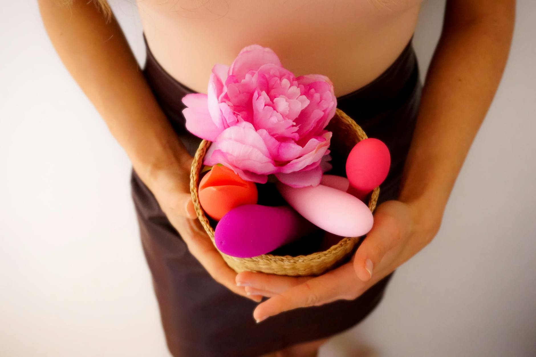 Vibrant photo of various colorful adult toys including lemon vibrators arranged on a bright yellow surface